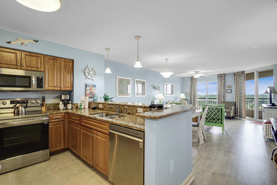 Your open-concept kitchen flows seamlessly into the living space, featuring granite countertops and stainless steel appliances perfect for preparing meals together.