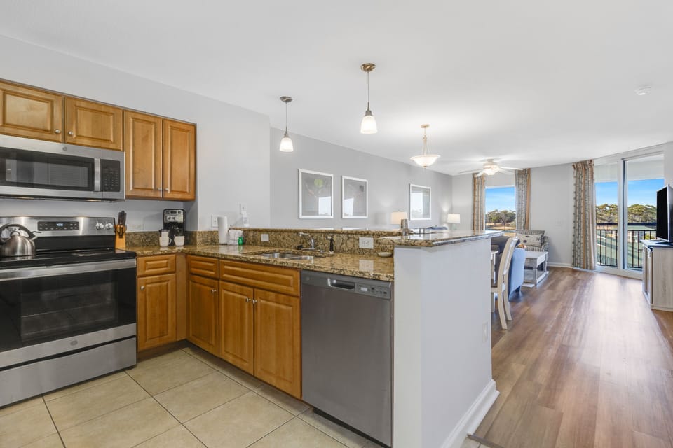 Cook your favorite meals in this fully equipped kitchen with granite countertops, stainless appliances, and open layout flowing to your dining space.