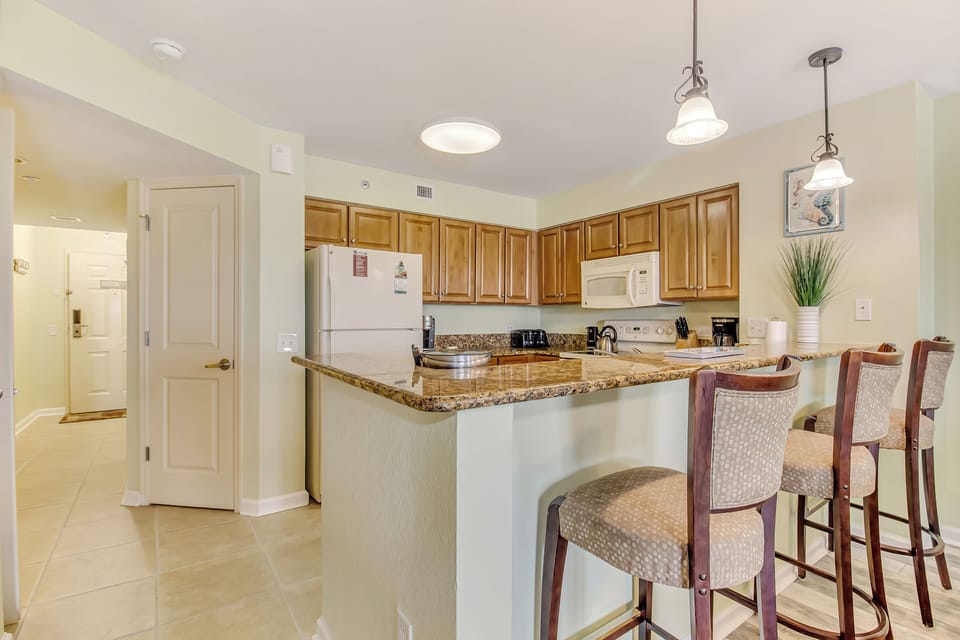 Your fully equipped kitchen features granite countertops, breakfast bar seating, and everything needed for memorable meals together.