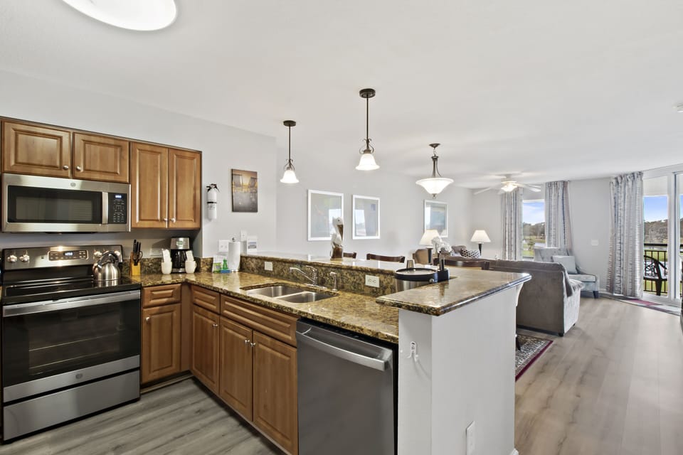 Cook meals with ease in your fully equipped kitchen featuring granite counters and stainless steel appliances that flow into your comfortable living space.