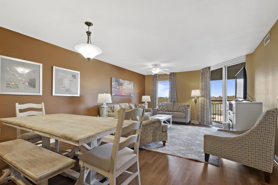Unwind in your spacious living area with warm golden walls and comfortable seating, perfect for relaxing after exploring nearby attractions.