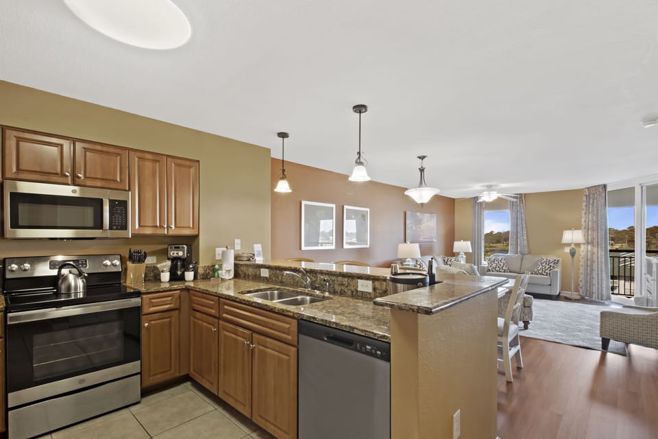 Your fully equipped kitchen flows seamlessly into the living space, perfect for preparing meals while enjoying natural light and relaxing.