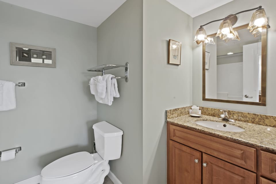 Your private bathroom features granite countertops, warm lighting, and fresh towels for your comfort.