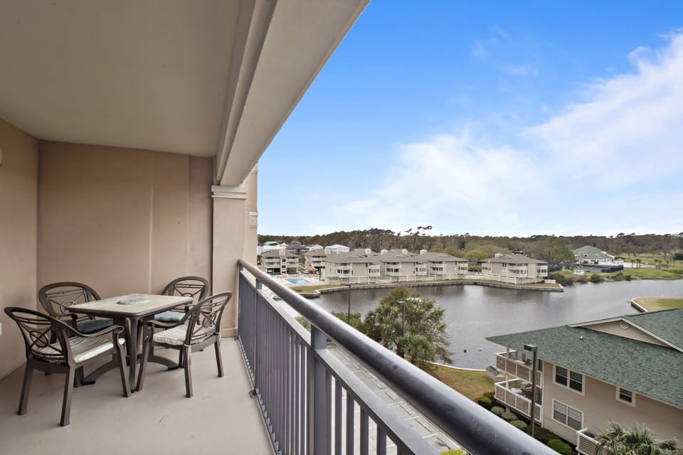 Step onto your private balcony and savor morning coffee while overlooking tranquil lake waters and surrounding buildings.