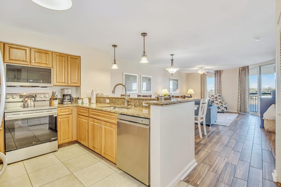 Cook your favorite meals in this bright, fully-equipped kitchen featuring granite counters, stainless appliances, and an open layout perfect for entertaining.