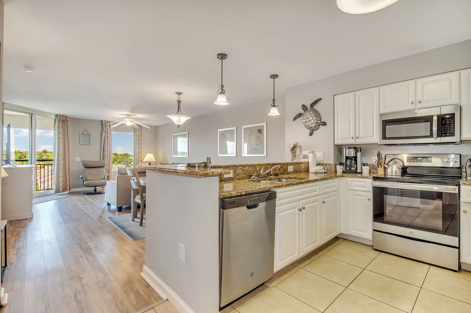 Your open-concept kitchen flows seamlessly into the living space, featuring granite counters and stainless appliances for effortless meal prep.