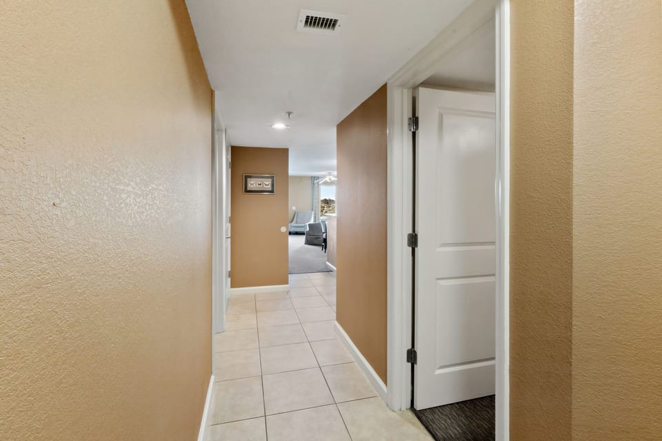 Step into your welcoming hallway with warm tones and sleek tile floors that lead to your comfortable living spaces.