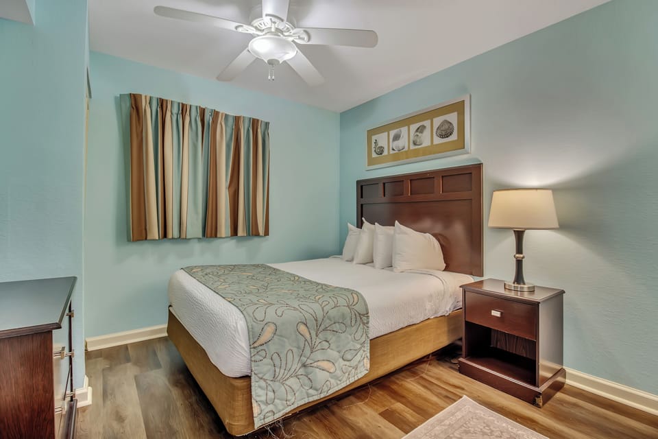 Drift off to sleep in your tranquil bedroom, where soothing seafoam walls and coastal artwork create the perfect seaside retreat.