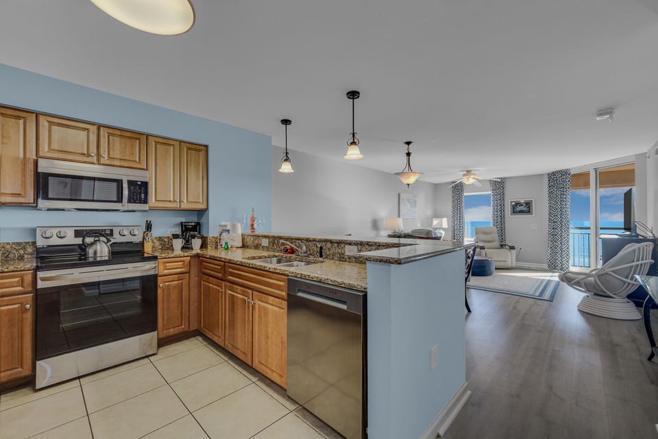 Your spacious open-concept living flows seamlessly from the fully-equipped kitchen to the bright living area with stunning ocean views.