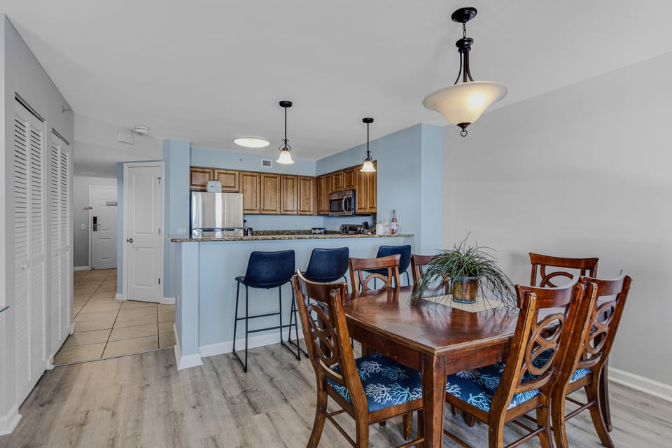 Gather around your spacious dining table for memorable meals with ocean-inspired touches and modern kitchen convenience at your fingertips.