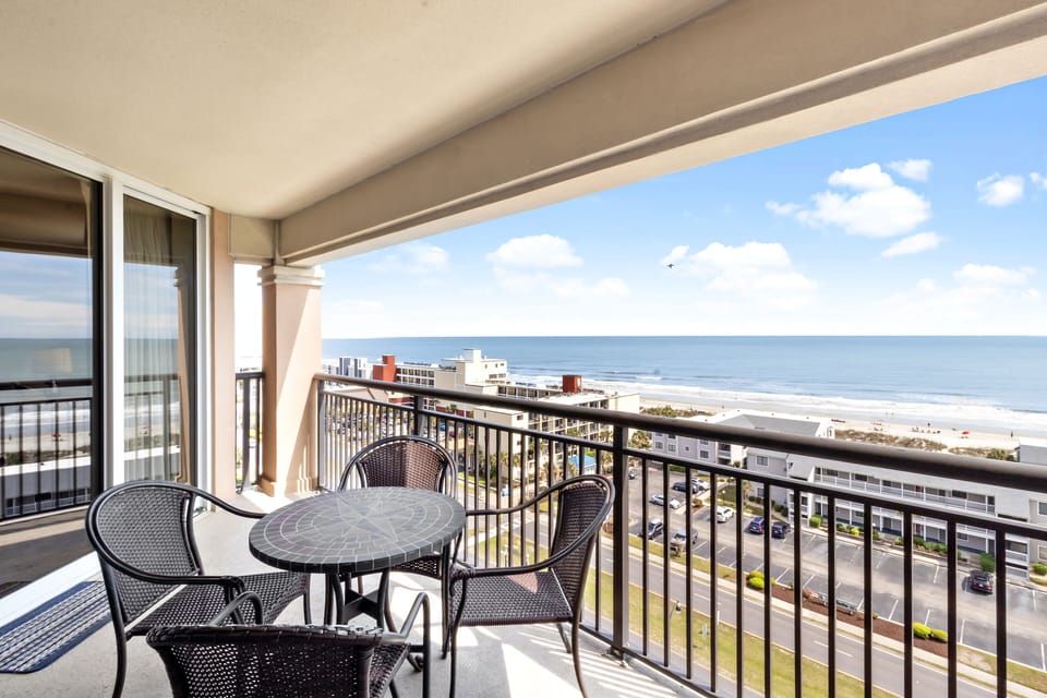 Step onto your private balcony and savor breathtaking ocean views. Enjoy morning coffee at your outdoor table while listening to gentle waves.