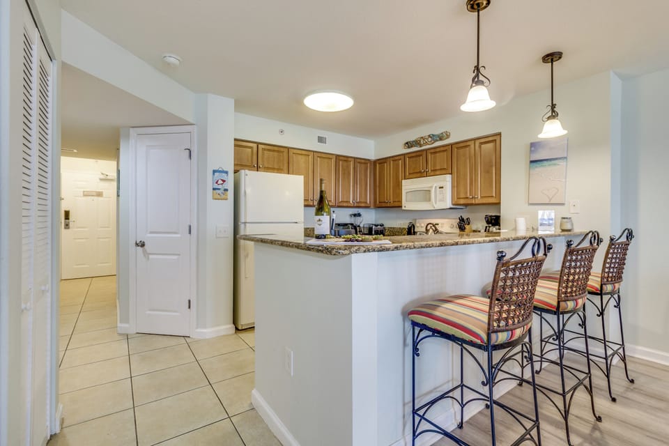 Your fully equipped kitchen features granite countertops, breakfast bar seating, and everything needed to prepare delicious meals during your stay.