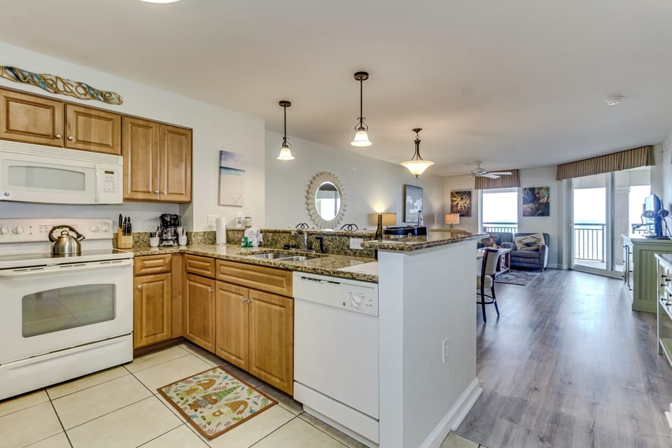 Your fully equipped kitchen opens to a bright living area, perfect for preparing meals while staying connected with your group.