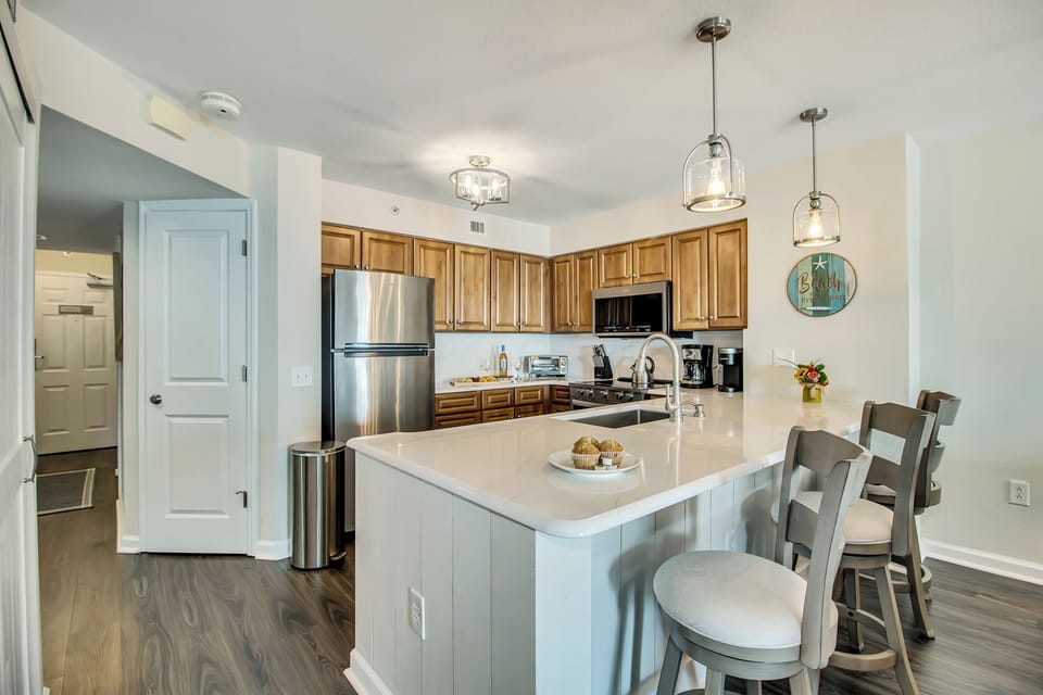 Your fully equipped kitchen invites culinary adventures with granite counters, modern appliances, and a breakfast bar perfect for morning coffee conversations.