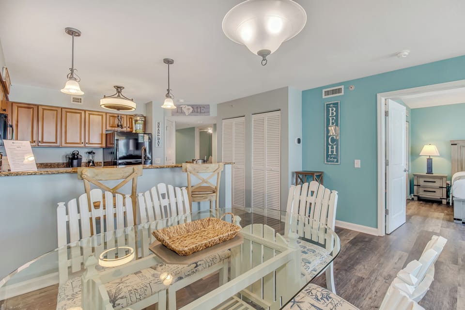 Your coastal-themed dining area flows seamlessly into the kitchen, with beach-inspired decor creating a relaxing atmosphere for meals.