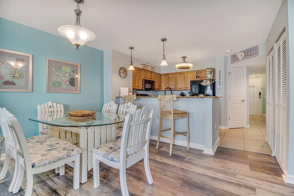 Gather around your bright, coastal-themed dining space with cheerful seating for six and a convenient breakfast bar perfect for morning coffee.
