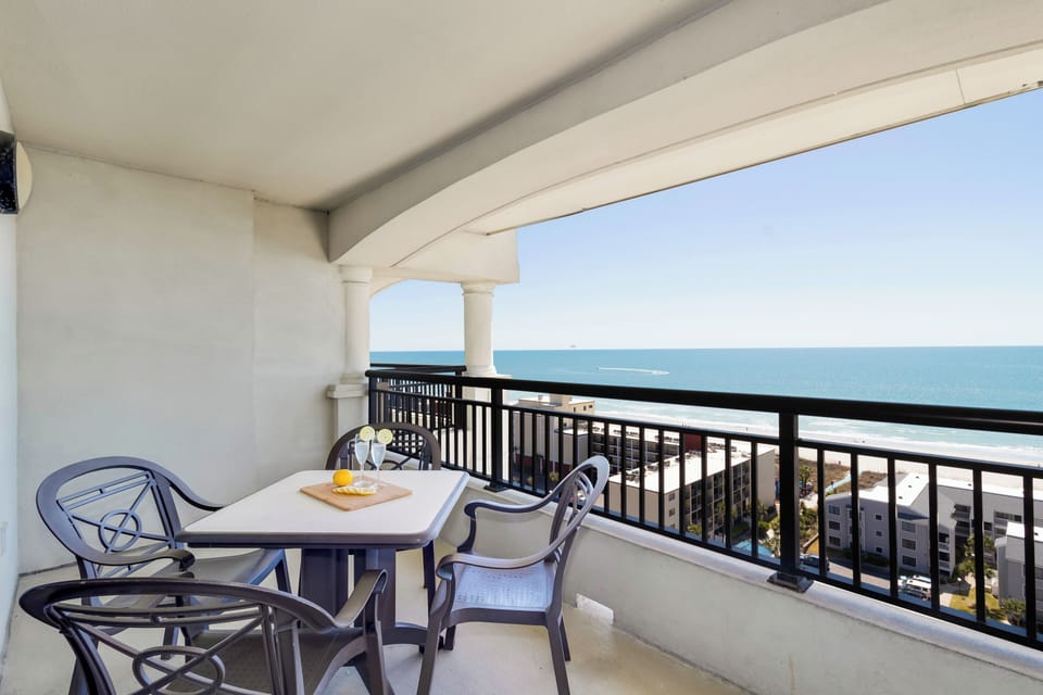 Savor morning coffee on your private oceanfront balcony with stunning sea views and comfortable dining space.