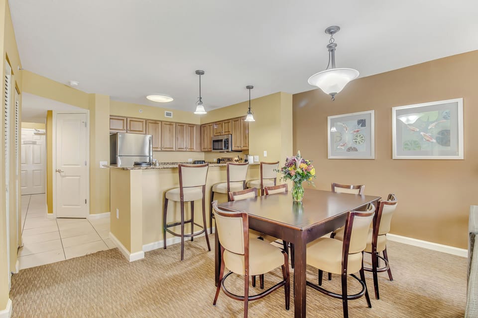 Gather around your spacious dining table where warm lighting creates perfect ambiance for memorable meals with loved ones.
