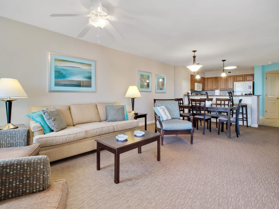 Relax in your spacious open-concept suite with coastal-inspired decor, comfortable seating, and a fully equipped kitchen perfect for family gatherings.