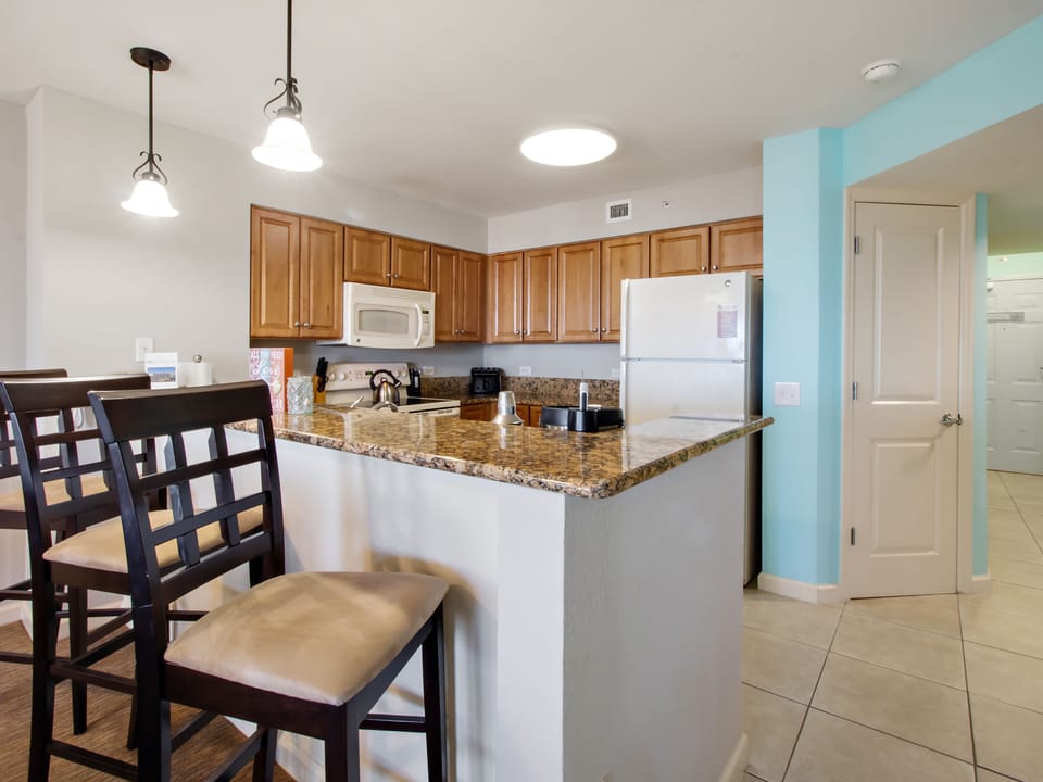 Your fully equipped kitchen welcomes you with granite countertops, warm wood cabinets, and a convenient breakfast bar for casual dining together.