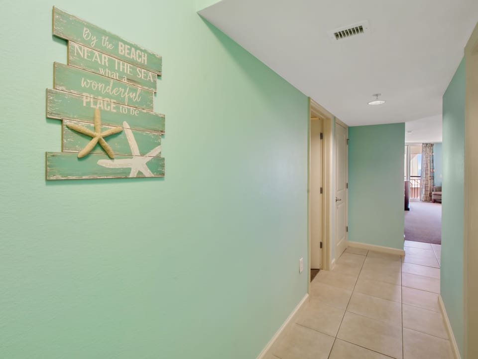 You'll love the coastal charm greeting you in this welcoming hallway, where beach-inspired decor sets the perfect vacation mood.
