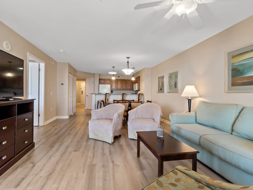 Unwind in this spacious open-plan living area with plush seating and coastal charm.