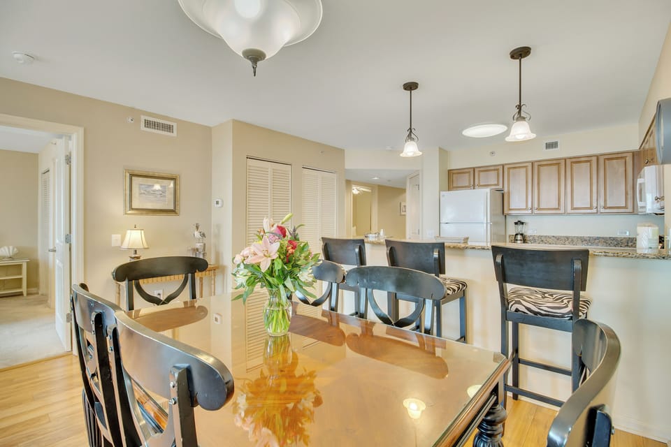 Gather around your elegant dining table where fresh flowers await and the open kitchen invites culinary adventures together.