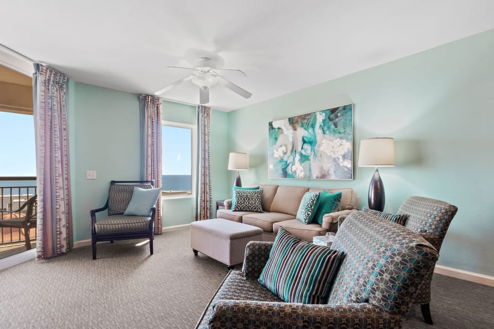 You'll love unwinding in this soothing coastal living room, where soft mint walls and comfortable seating create your perfect retreat.