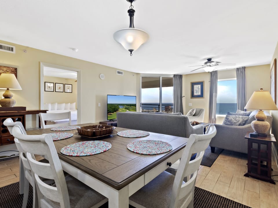 Your oceanfront suite combines dining and living spaces with breathtaking sea views through floor-to-ceiling windows.