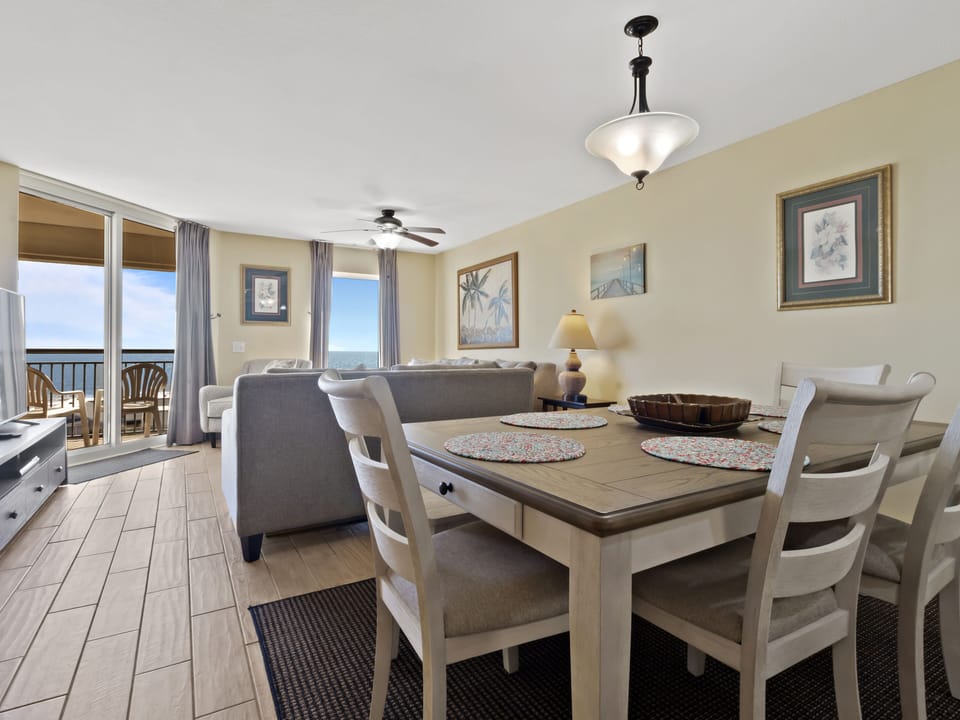 Your dining space flows seamlessly into the living area, where ocean views frame every meal through floor-to-ceiling windows.