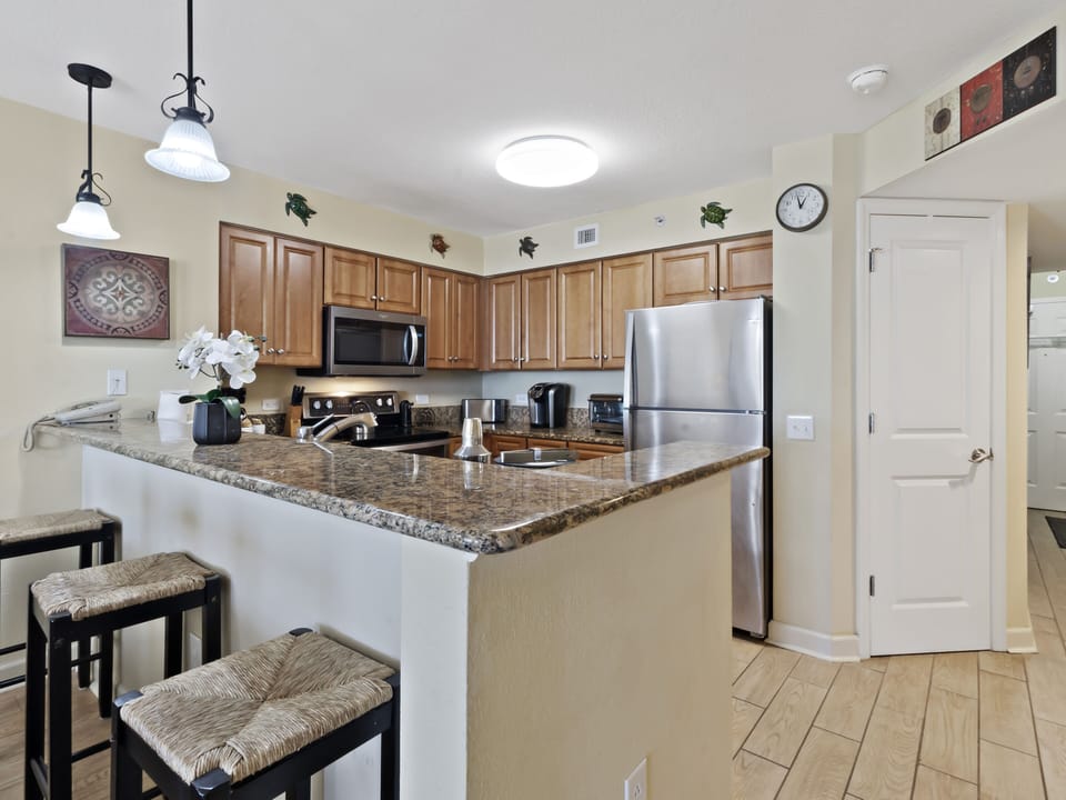 Your fully equipped kitchen awaits with granite counters, stainless appliances, and breakfast bar seating for morning coffee or casual meals together.
