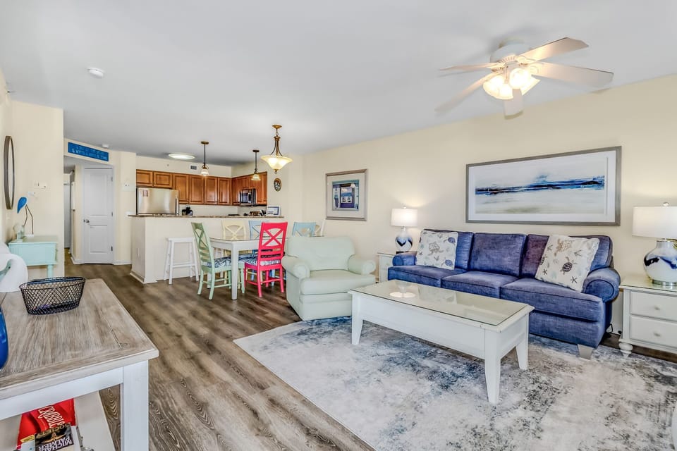 Relax in your spacious open-concept living area with comfortable seating, modern amenities, and coastal charm throughout.