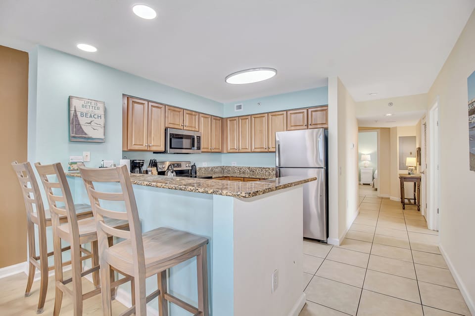 Your coastal-themed kitchen features granite counters, stainless appliances, and breakfast bar seating for memorable vacation meals together.