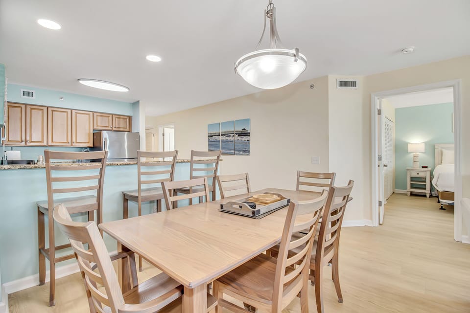 Gather around this welcoming dining table where your group can share meals and create memories in this bright, open living space.
