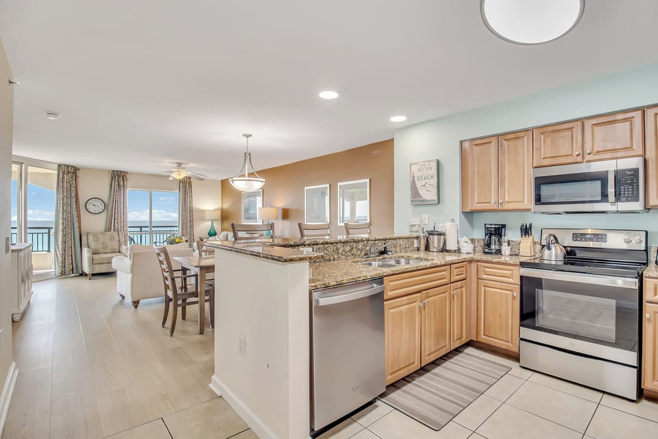 Your spacious oceanfront kitchen flows seamlessly into the living area, featuring granite counters and stainless appliances for memorable meals with sea views.