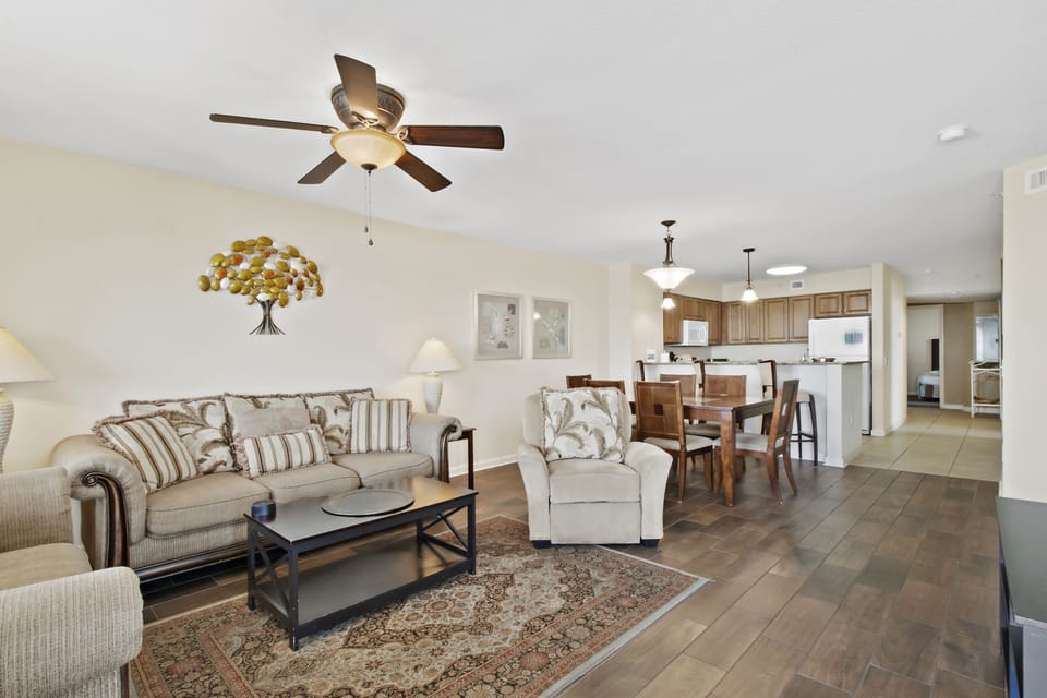 Relax in your spacious open-plan retreat with comfortable seating, modern kitchen, and soothing neutral tones perfect for unwinding.