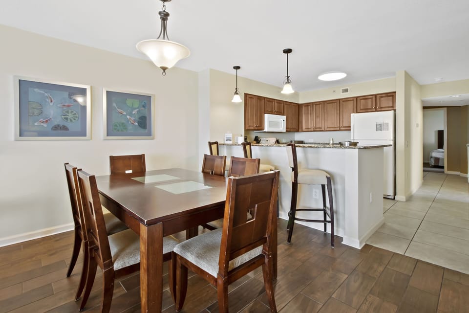 Gather around your elegant dining table for memorable meals in this open-concept space featuring warm wood tones and granite counters.