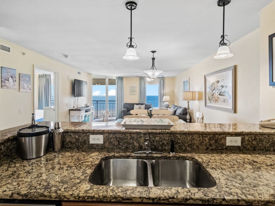 Cook while enjoying stunning ocean views from your granite kitchen counter, with the sea breeze flowing through this bright, open space.