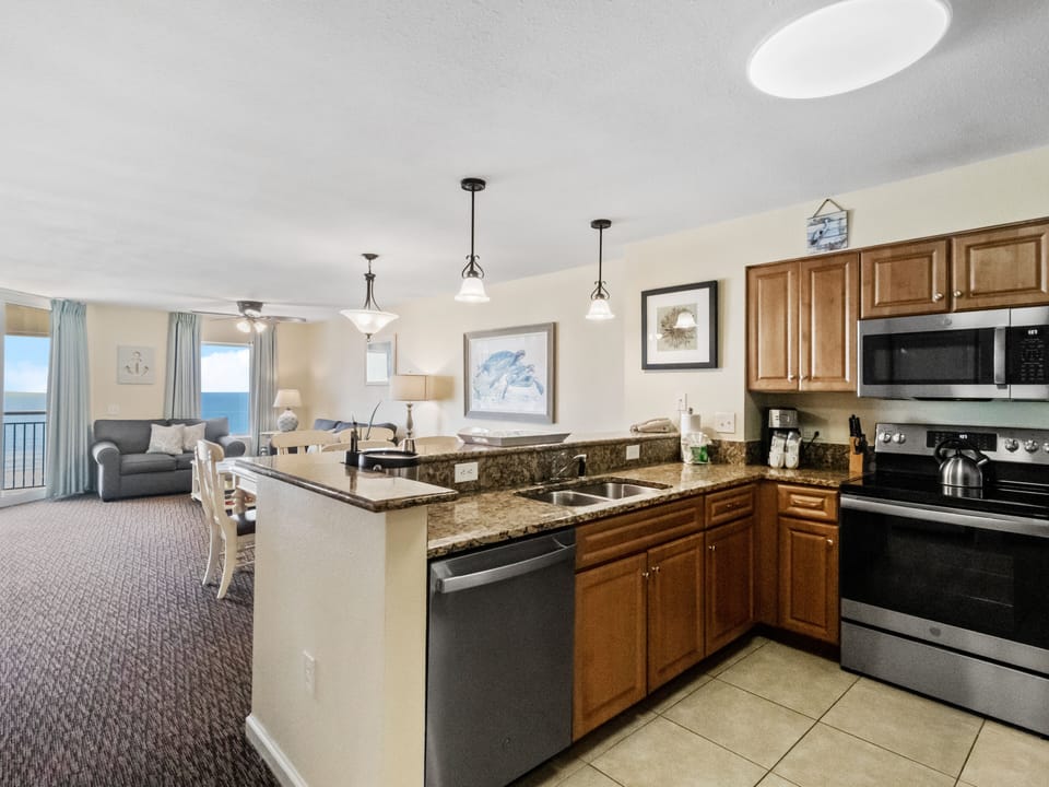 Your fully equipped kitchen flows seamlessly into the living area, with granite counters perfect for meal prep while enjoying ocean views.