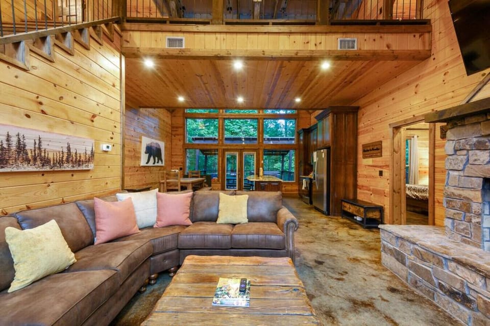 Cozy up by the fireplace in this cabin retreat, where an open kitchen invites warmth and togetherness.
