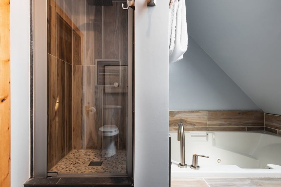 Bedroom 2's ensuite features a large tub and walk-in shower.