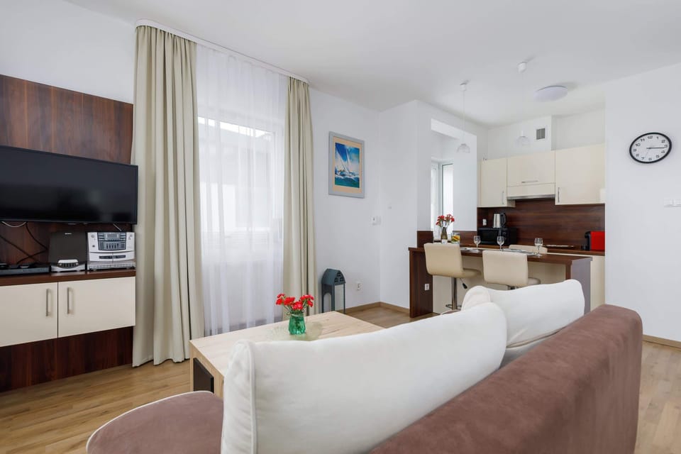 A spacious bedroom that includes a brown sofa near the bed, making it a versatile space.