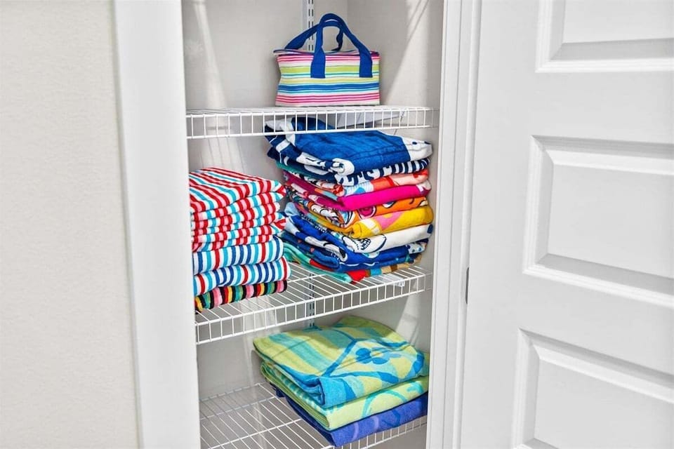A neatly arranged storage space with beach towels ready for a fun day by the water.