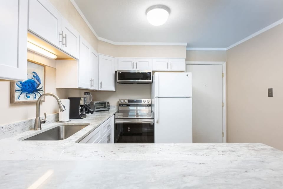 Fully Equipped Kitchen with Refrigerator, Stove, Oven, Microwave, Dishwasher, Coffee Maker and Toaster and Generous Counter Space for Cooking and Entertaining