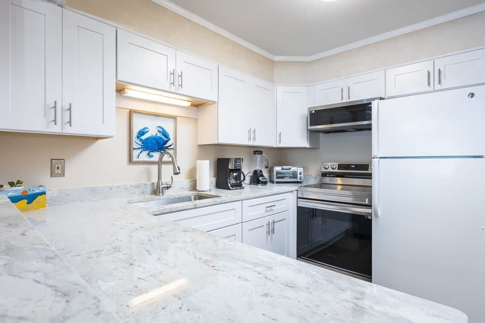 Fully Equipped Kitchen with Refrigerator, Stove, Oven, Microwave, Dishwasher, Coffee Maker and Toaster and Generous Counter Space for Cooking and Entertaining