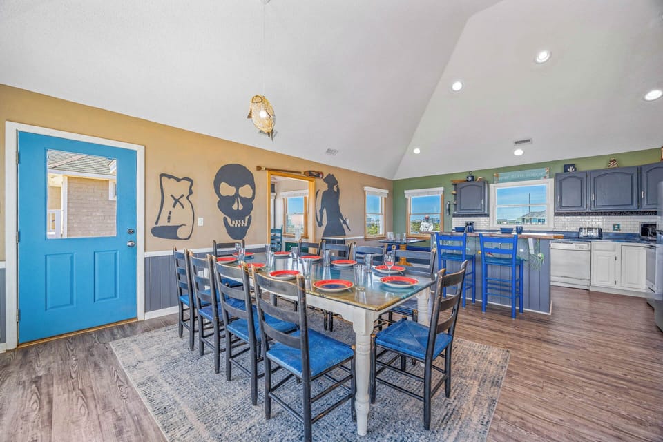 Gather your crew around this spacious dining table, where fun coastal touches and an open kitchen invite shared meals and easy conversation.