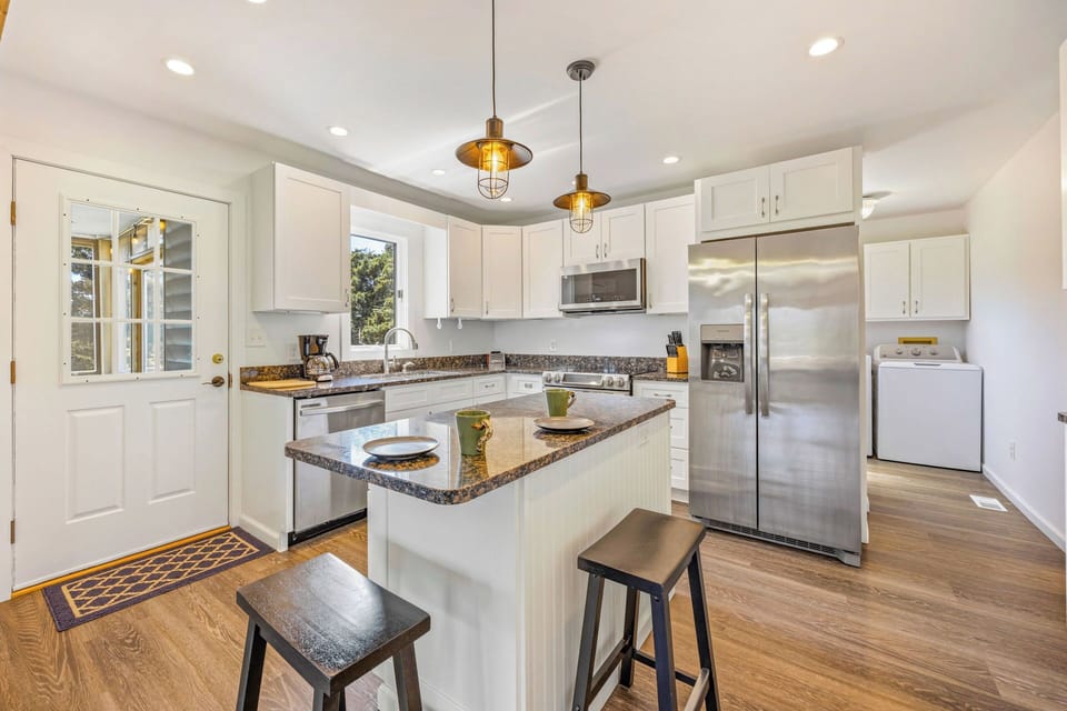 Your fully equipped kitchen features granite countertops, stainless steel appliances, and a center island where you can prep meals or enjoy casual dining together.