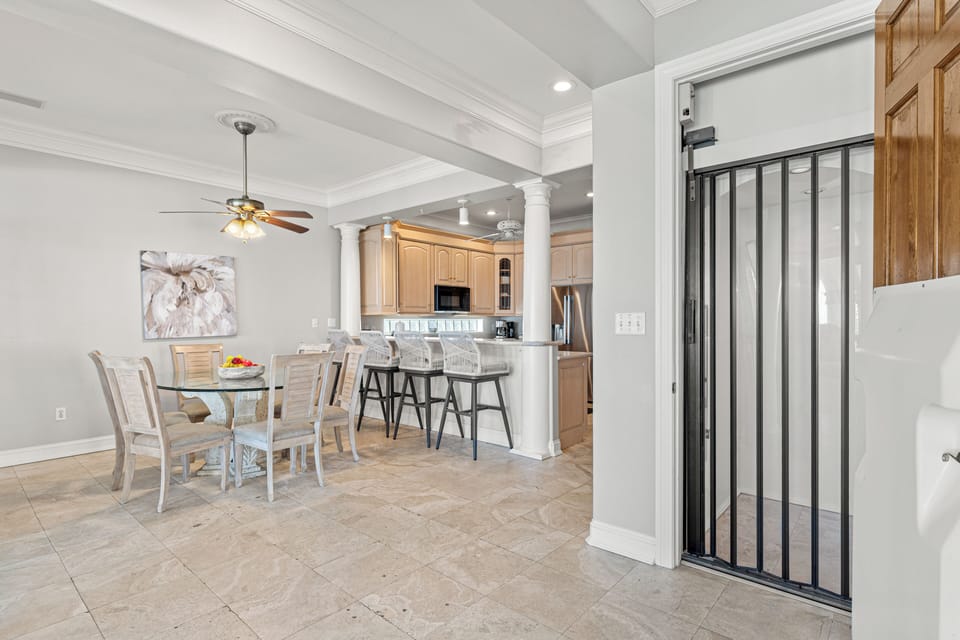 Your open-concept kitchen and dining area features warm wood cabinetry, granite countertops, and a breakfast bar perfect for morning coffee.