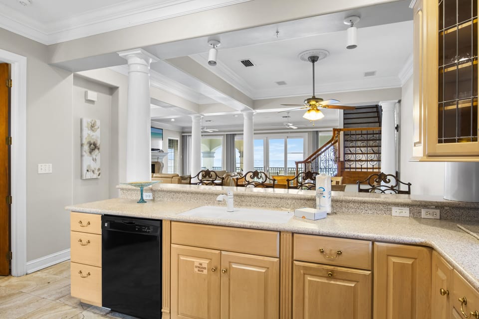 Your gourmet kitchen flows into an elegant living space with granite counters and rich wood cabinetry.