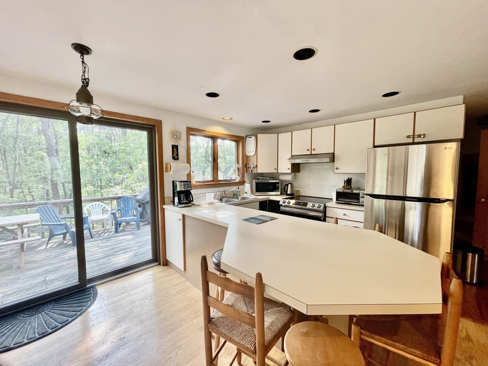Full Kitchen opens up to deck with sliding doors, with all essential appliances